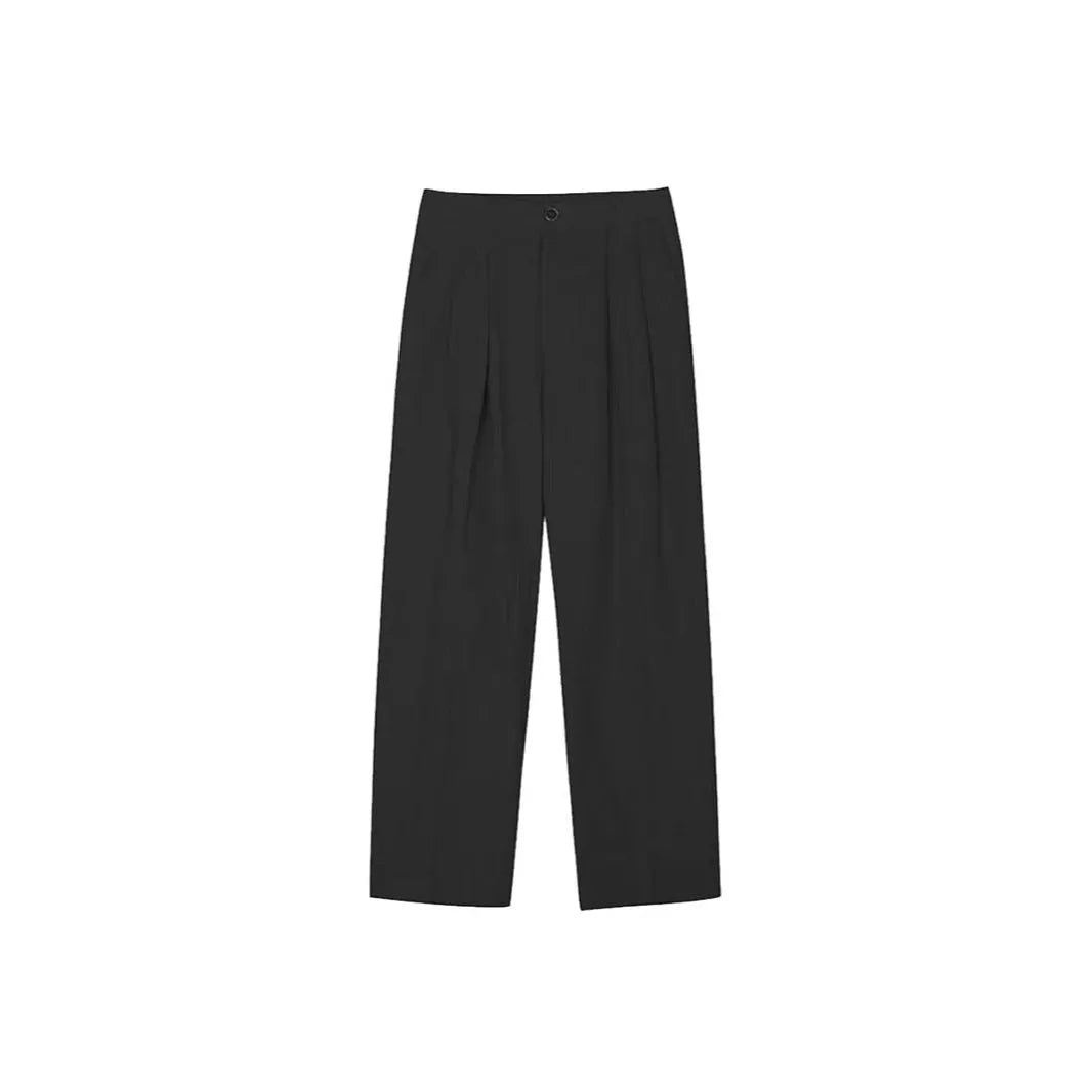 Man wearing loose apricot wide-leg cotton linen blend trousers with a pencil-leg opening.