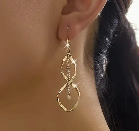 Gold spiral design diamond earrings with geometric shape and elliptical elements