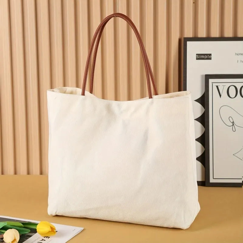 Heavy-duty natural cotton canvas tote bag with flat base and long handles in beige white colour.