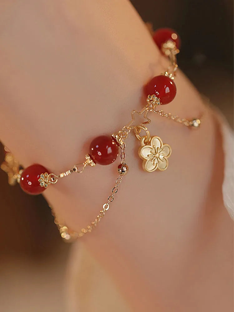 Close-up of natural red agate double layer bracelet with manual floral and peach blossom details for women.
