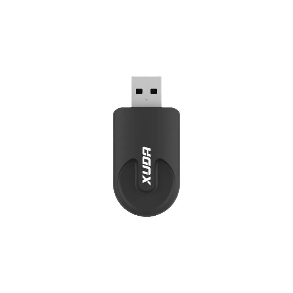 Small black 2-in-1 USB car adapter for wireless CarPlay and data transfer on a dark surface.