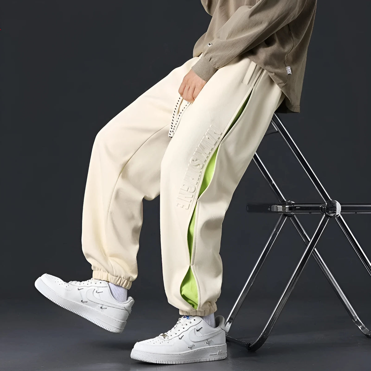 Men's loose-fit cotton trousers with stitching print design and ankle band in grey green.