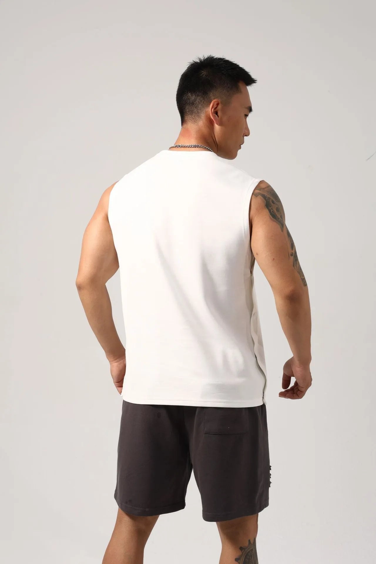 Men's black Korean style loose fitness vest with hidden hook openings on the sides