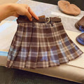 Girls' cotton plaid pleated skirt in A-line style showing pleat detail and plaid pattern