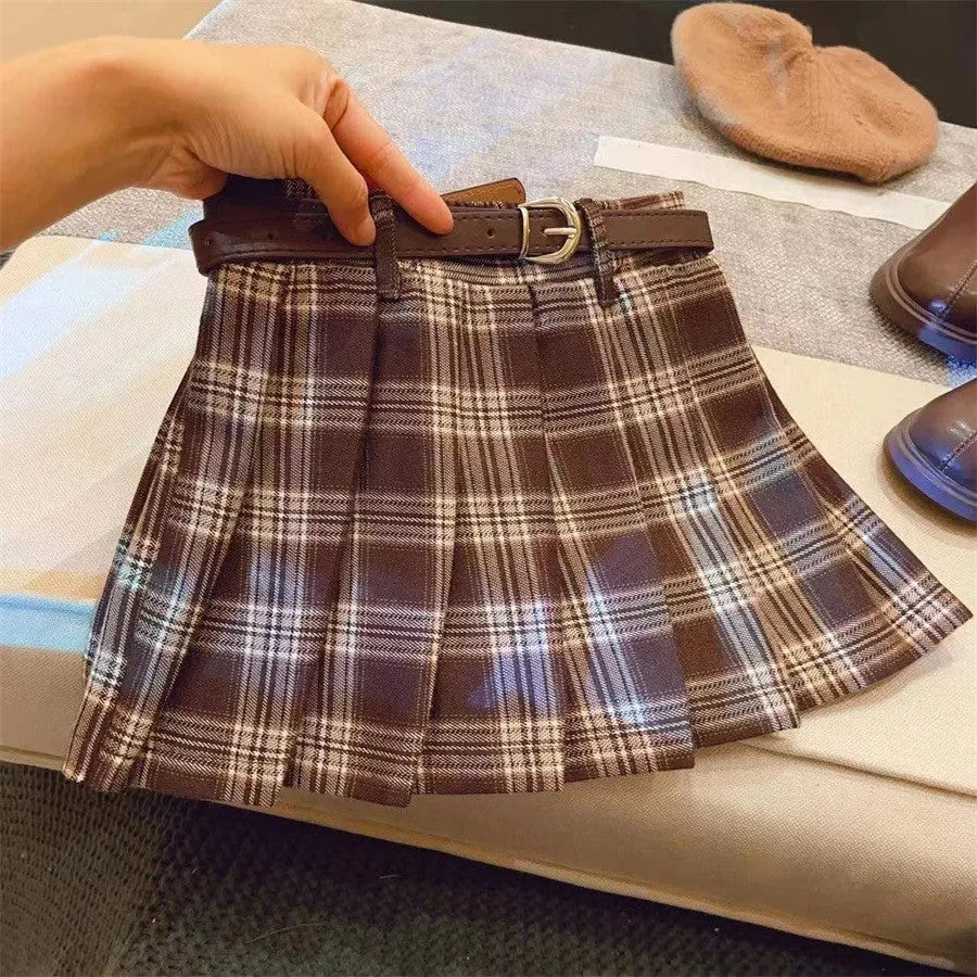 Girls' cotton plaid pleated skirt in A-line style showing pleat detail and plaid pattern