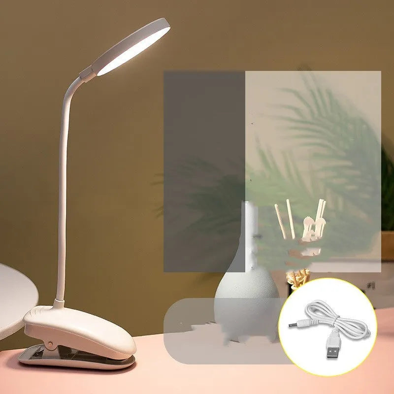 LED clip-on desk lamp with touch dimming, plastic shade, available in white, pink, or green.