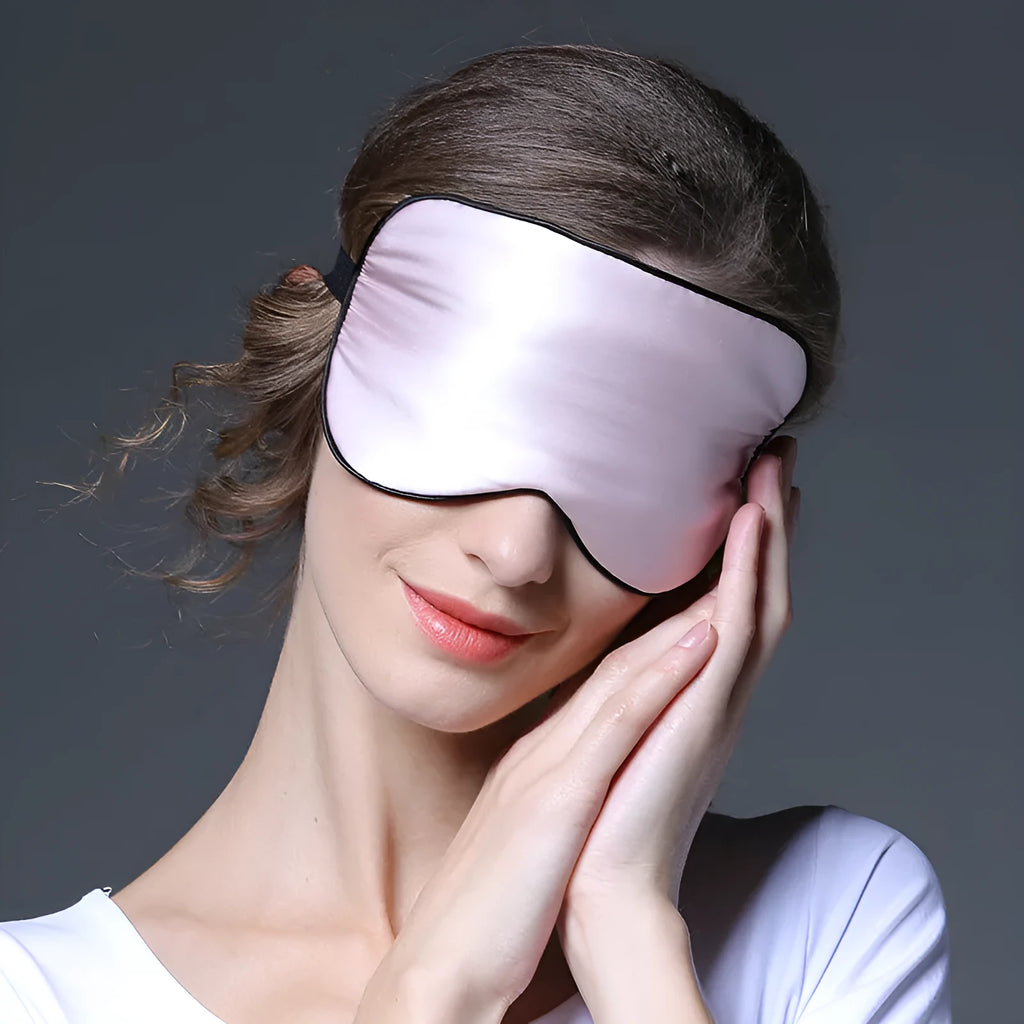 Double-sided Mulberry silk sleep eye mask showing embroidered detail, in a selection of colours on a neutral background.