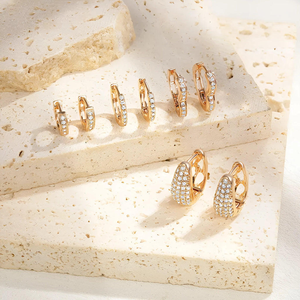 Gold plated heart shaped ear clip earrings with cubic zirconia stones, clip-on back visible