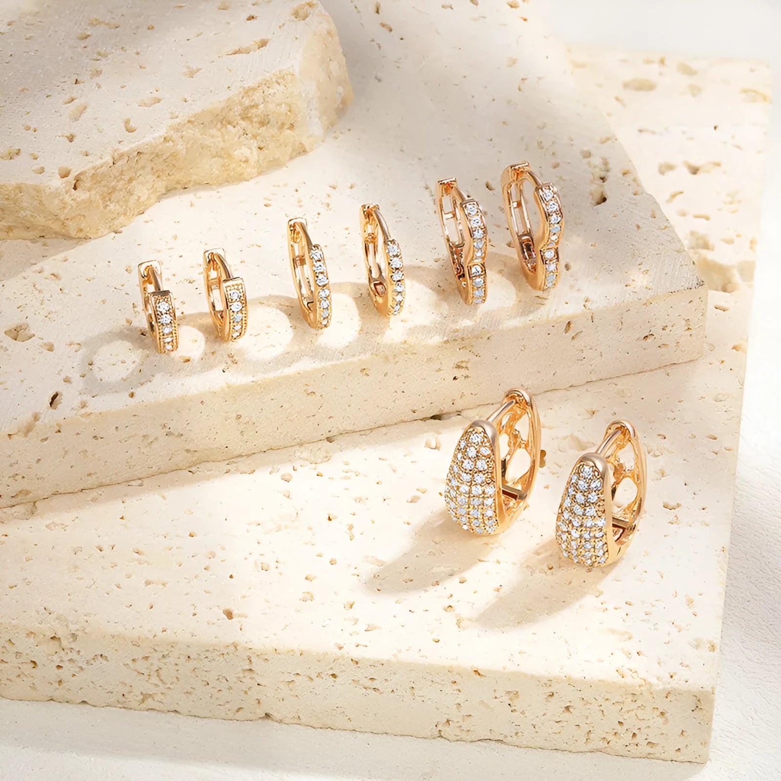 Gold plated heart shaped ear clip earrings with cubic zirconia stones, clip-on back visible