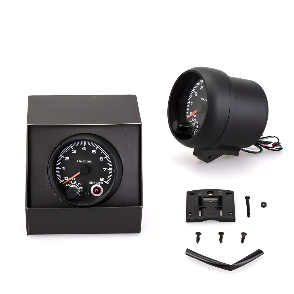 Black universal car tachometer with blue pointer on dial showing 0-8000 RPM range.