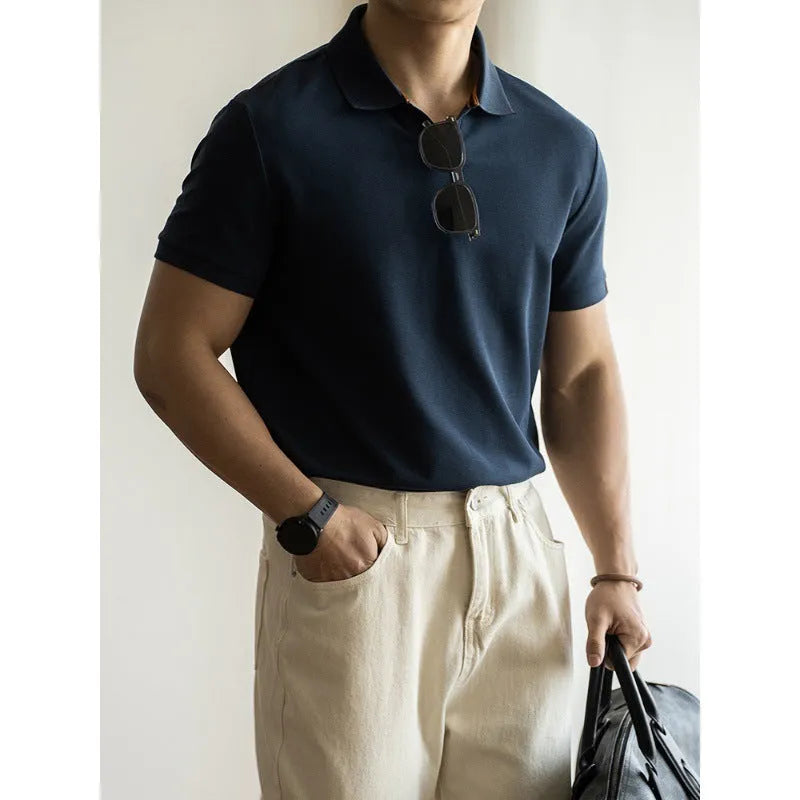 Blue short-sleeved cotton blend polo shirt on a hanger, showing regular fit and button placket.