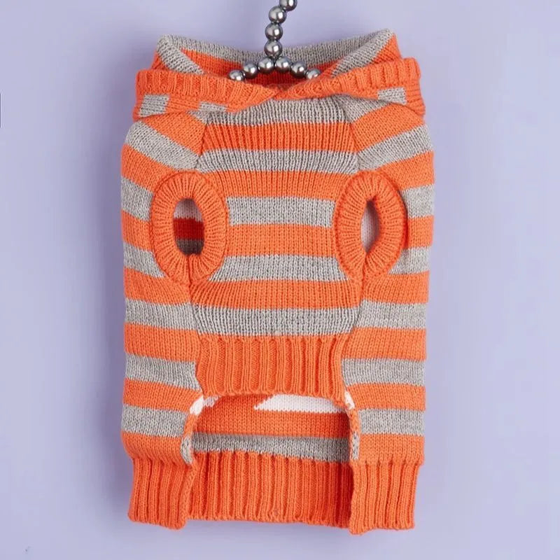 Orange knitted pet sweater with striped pattern, hood and fur balls for Halloween